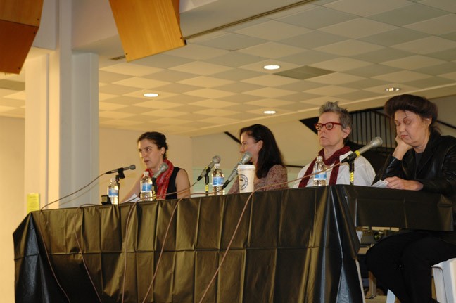 Andrea Fraser, Catherine Lord, Mary Kelly, and moderator Elana Mann at a panel table.
